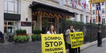 Protesters against Sompo Insurance hold banners saying: Sompo: Stop Insuring Elbit and No New Workers For Genocide Insurers