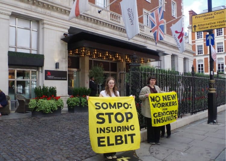 Protesters against Sompo Insurance hold banners saying: Sompo: Stop Insuring Elbit and No New Workers For Genocide Insurers