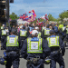 Police from Sussex follow behind protestors raising flags at a protest in Brighton which led to Ryan Bridge being arrested for common assault
