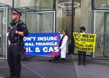 Protest at office of insurance company Swiss Re Banners say: Don't Insure Coral Triangle Oil & Gas No New Workers For Fossil Fuel Insurers
