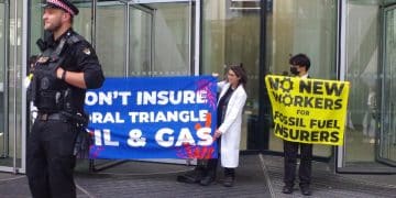 Protest at office of insurance company Swiss Re Banners say: Don't Insure Coral Triangle Oil & Gas No New Workers For Fossil Fuel Insurers