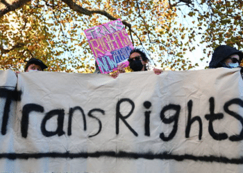 Trans rights activists hold placard