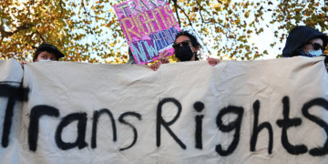 Trans rights activists hold placard