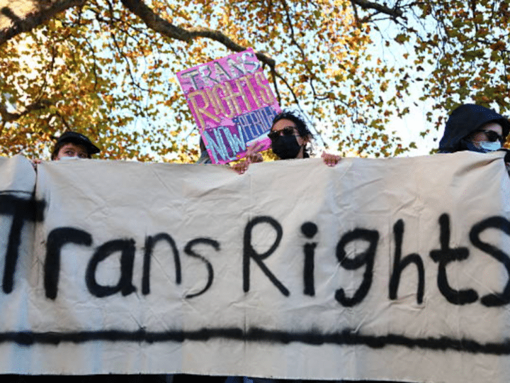 Trans rights activists hold placard