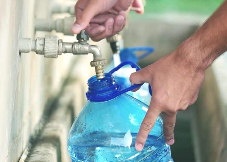 Running water Bottle filling up from tap