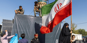 A woman is seen holding the Iranian Flag on June 15, 2026 in Tehran, Iran. According to reports, the U.S. and Iran have signed a preliminary agreement to end the war and open the Strait of Hormuz. The UAE is alleged to have agreed to unlock funds frozen in foreign banks under US sanctions for Iran.