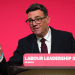 Andy Burnham on a podium speaking for the first time as the UK's Labour leader