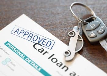 Image of car loan agreement and car key Economic abuse using car finance