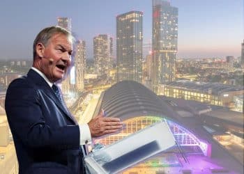 Rupert Lowe of Restore Britain and a scene of Manchester city centrescape with vibrant infrastructure in the background