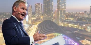 Rupert Lowe of Restore Britain and a scene of Manchester city centrescape with vibrant infrastructure in the background