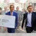 Nigel Farage and George Cottrell and a Reform UK business card