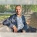 Zack Polanski of the Green Party sat on a bench outside in a relaxed manner posing for camera