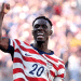 Folarin Balogun #20 of the United States celebrates scoring his team's first goal during the FIFA World Cup 2026 Round of 32 match between USA and Bosnia-Herzegovina on July 1, 2026 in Santa Clara, California, with a bicep flex