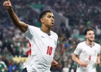 England player Jude Bellingham celebrates scoring their first goal with one hand in the air and his index finger making a 'number 1'