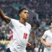 England player Jude Bellingham celebrates scoring their first goal with one hand in the air and his index finger making a 'number 1'
