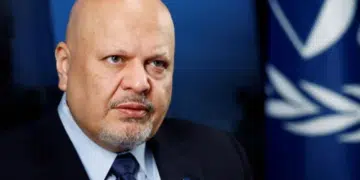 Karim Khan, ex-ICC prosecutor, who has a bald head and piercing eyes, looks stern as he stares into the distance