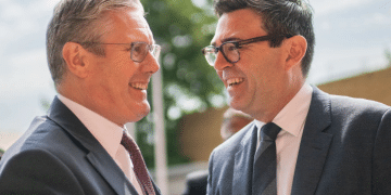 Keir Starmer and Andy Burnham greeting one another and smiling in close proximity