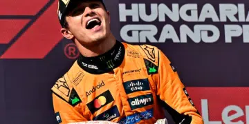 Lando Norris celebrates on the podium with a trophy after winning the Hungarian Grand Prix