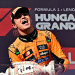 Lando Norris celebrates on the podium with a trophy after winning the Hungarian Grand Prix