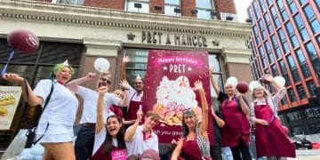 Campaigners outside Pret with a giant birthday card