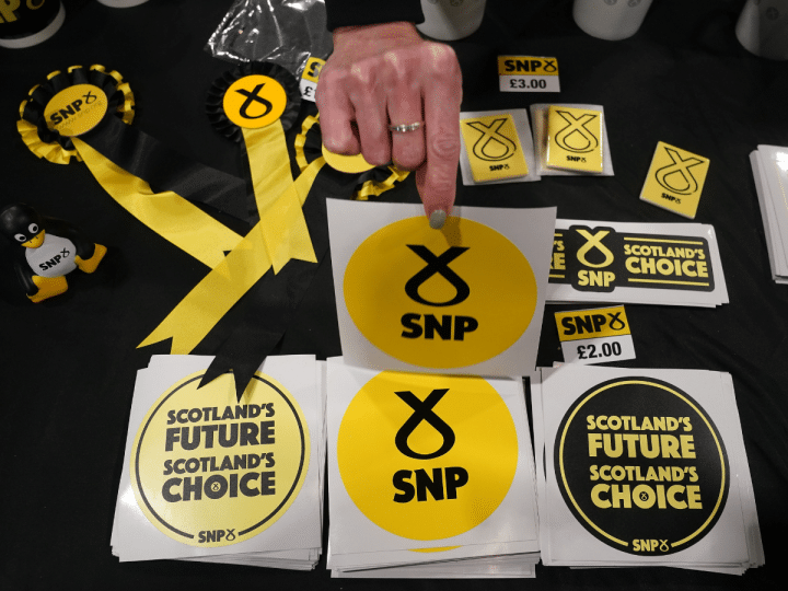A table with SNP promotional items like stickers that say 'Scotland's Future, Scotland's Choice', and ribbons, in October 2022