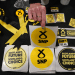 A table with SNP promotional items like stickers that say 'Scotland's Future, Scotland's Choice', and ribbons, in October 2022