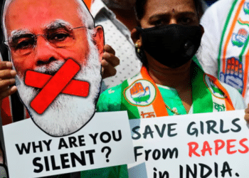 An activist holds a cut-out of the prime minister of India, Narendra Modi, at a protest over another gang-rape and murder of a young woman in Uttar Pradesh state in 2020