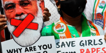 An activist holds a cut-out of the prime minister of India, Narendra Modi, at a protest over another gang-rape and murder of a young woman in Uttar Pradesh state in 2020