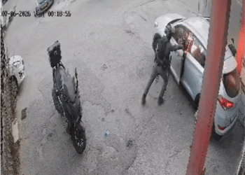 Screenshot of CCTV footage showing an Israeli officer pushing his weight against the car door and inside the vehicle is lit up orange as the grenade has exploded.